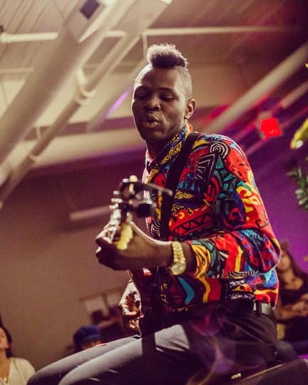 Bisi performing live under stage lights